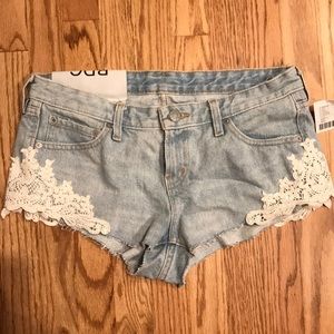 BDG Cut off denim shorts with lace details